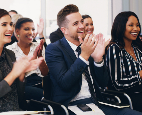 Business people, applause and conference audience, crowd and tradeshow workshop, training and motivation for presentation. Happy corporate team, clapping hands and success, goals and support meeting